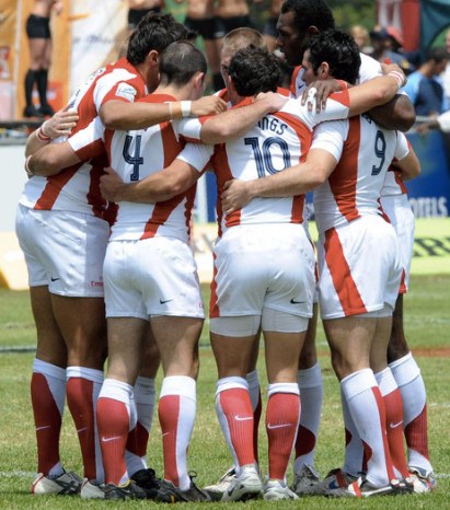 Group of athletes forming a circle planning a game strategy